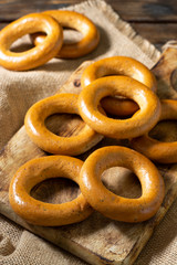 Bagels on a wooden plate on a brown wooden table. Rustic style. Homemade cake