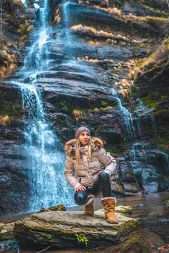 Cascada Uguna, Bizkaia / Spain &raquo;; January 20, 2020: A smiling blonde in the natural park below the waterfall