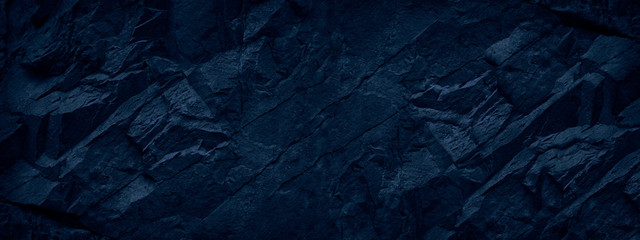 Abstract black stone background. Deep blue grunge background. Toned mountain texture. Volumetric rock backdrop.
