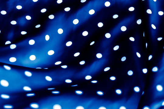 Classic polka dot textile background texture, white dots on blue luxury fabric design pattern