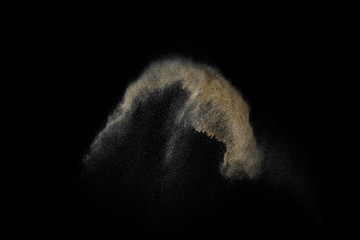Sandy explosion isolated on black background. Abstract particles cloud. Texture element for design.