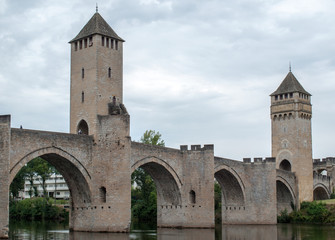 Fototapeta na wymiar Cahors, France - September 15, 2018: The medieval Pont Valentre over the River Lot, Cahors, The Lot, France