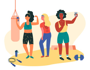 Three females doing sweaty selfie check-ins during gym session. Asian, black and white girls working out at fitness class with jump rope, dumbell, punching bag, platform. Functional training.
