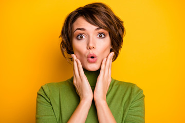 Closeup photo of short hairstyle pretty lady eyes full of fear frightened open mouth listen awful news arms on cheeks wear casual green turtleneck isolated yellow color background