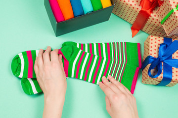 Colorful collection of cotton socks as a gift in woman hands.