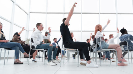 group of young people sitting in a bright conference room.