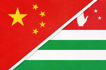 People's Republic of China or PRC vs Abkhazia national flag from textile. Relationship between two asian countries.