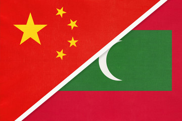 People's Republic of China or PRC vs Maldives national flag from textile. Relationship between two asian countries.