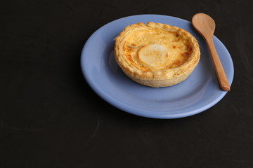 Delicious three cheese quiche in colored background
