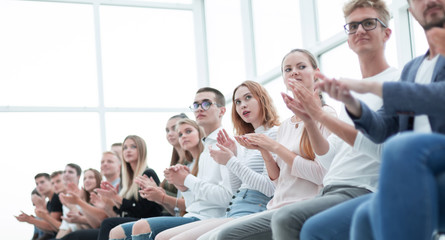 group of diverse young people sitting in a row