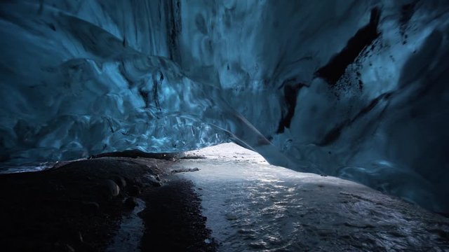 Move through glacier river in Ice Cave in Iceland