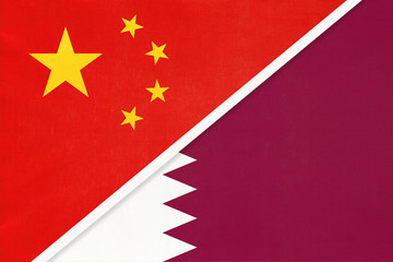 People's Republic of China or PRC vs Qatar national flag from textile. Relationship between two asian countries.