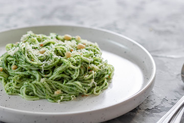 Green pasta with avocado, spinach and pine nuts