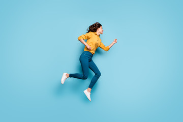 Obraz premium Full length body size profile side view of nice attractive purposeful cheerful cheery wavy-haired girl jumping running fast isolated on bright vivid shine vibrant green blue turquoise color background