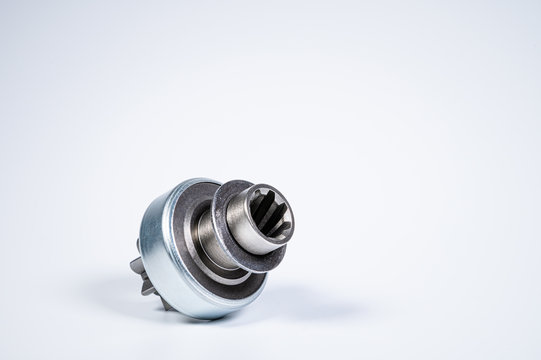 New spare parts - starter gear drive for motor starter on a gray background. Classic gear transmission via torque transmission