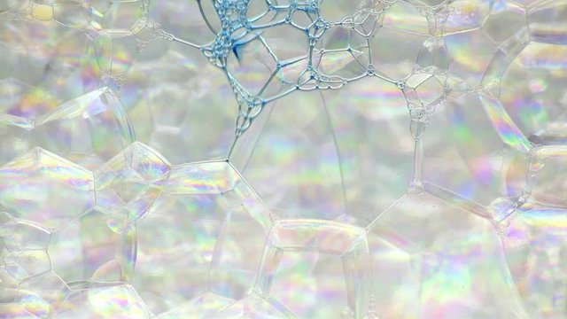 Colorful soap foam with popping bubbles background. Abstract biological structure, macro molecule pattern. Bright ink filling mass of small & big bubbles formed in liquid. Natural, unusual wallpaper