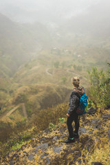 Naklejka premium Santo Antao Island Cape Verde. Female tourist with backpack enjoying hiking path route to Paul valley