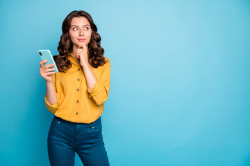 Photo of pretty lady holding telephone hands thinking over creative post text idea looking empty...