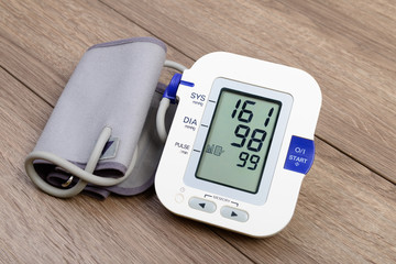 automatic blood pressure monitor on wooden table