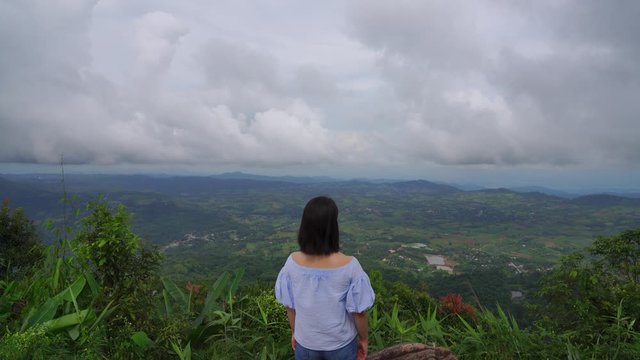 young japanese teen girl brunette tourist adult woman asian mature backpack looking the sky outdoors on a hike mountains viewpoint at khao kho, Phu Thap Boek, Phetchabun, Thailand.