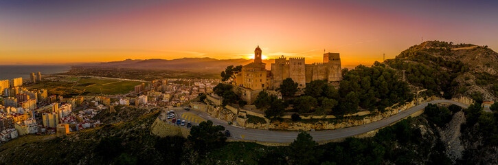 Cullera castle and church on a hilltop overlooking the popular summer resort town and the Mediterranean  in Spain