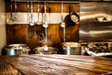 Desk of free space for your decoration and blurred background of kitchen.Copy space and sunny day. 