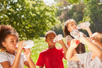 Children drink water during summer excursion