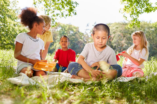 Multicultural children having a picnic in summer