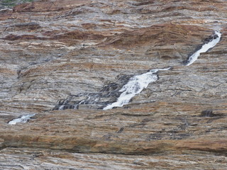 Scenic waterfall over Austerdalsvatnet lake, Svartisen glacier, Norway
