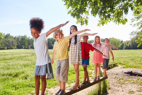 Children Balancing On A Beam