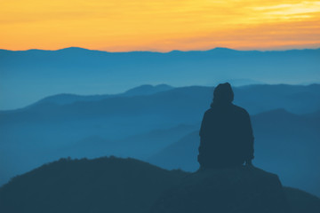 People sitting and watching the sunrise in the morning