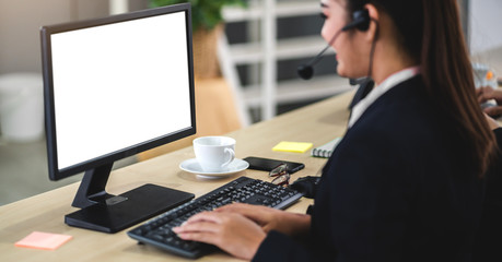Beautiful businesswoman customer support services working with headset and computer with white...