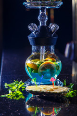 Manufacturing of hookah in the pineapple. The cut pineapple lies in the bowl of the hookah. Round...