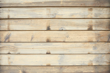 Fototapeta na wymiar Wooden texture background with rough horizontal planks in sunlight
