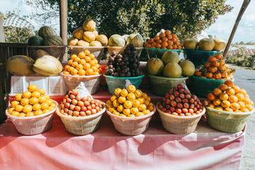 tropical fruits in baskets, lichee, mangosteen, meloneand other on fruit market, Kintamani, Bali Indonesia
