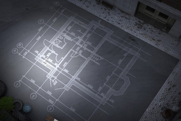 Construction drawings on floor . Mixed media