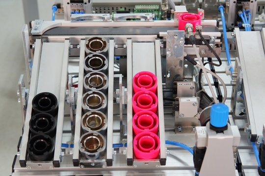 close-up of a vertical storage rack of a smart factory. Products which are placed according to color. Industry 4.0 concept, smart factory manufacturing line is equipped with sensors.