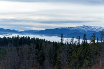 An image of white clouds over beautiful mountains