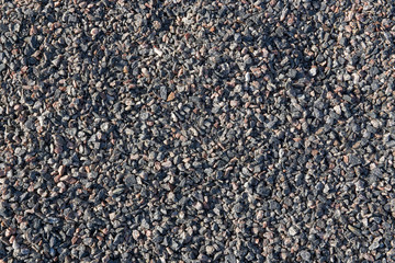 Fine crushed granite. The stone is gray with a splash of pink and red.