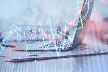 Stock market graph on background with desk and personal computer. Double exposure. Concept of financial analysis.