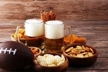 Chips, salty snacks, football and Beer on a table. Great for Bowl Game snack projects.