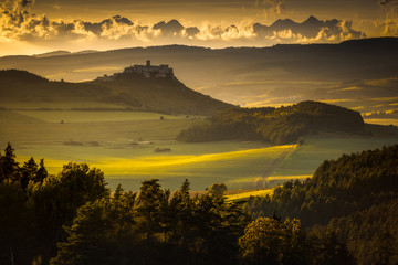 Spiski castle with Tatra Mountains as bacground in golden hour.