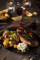 Beef Steak and Side Dish of Baked Potatoes and Mushrooms