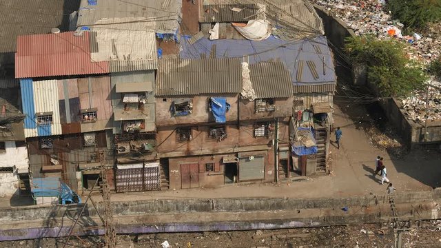 Slums in Bombay, India, by railroad tracks. Aerial view.