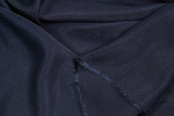 The fabric is blue silk. Blue textile drapery