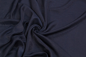 The fabric is blue silk. Blue textile drapery