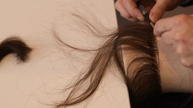 Closeup on process of making wigs