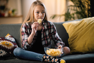 Teenage girl watching TV. Pretty girl watching drama film.