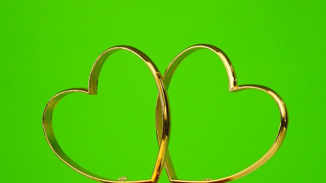 Heart as a symbol of love rotates on a green screen.