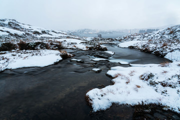 Water stream and winter landscape. Lofoten islands, Norway.